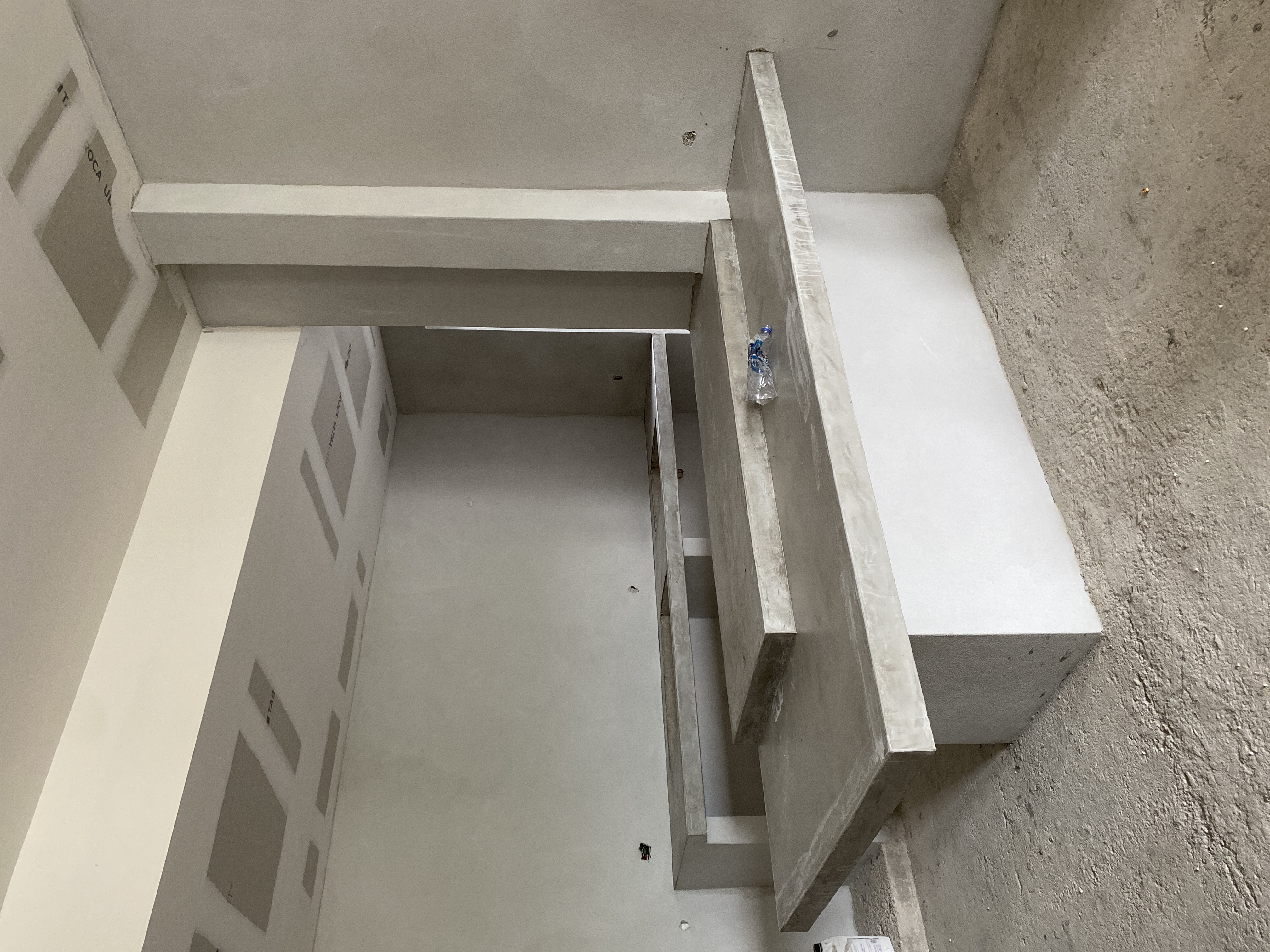 Interior Argentina — detalle de escalera y muros de concreto aparente en etapa de acabados
