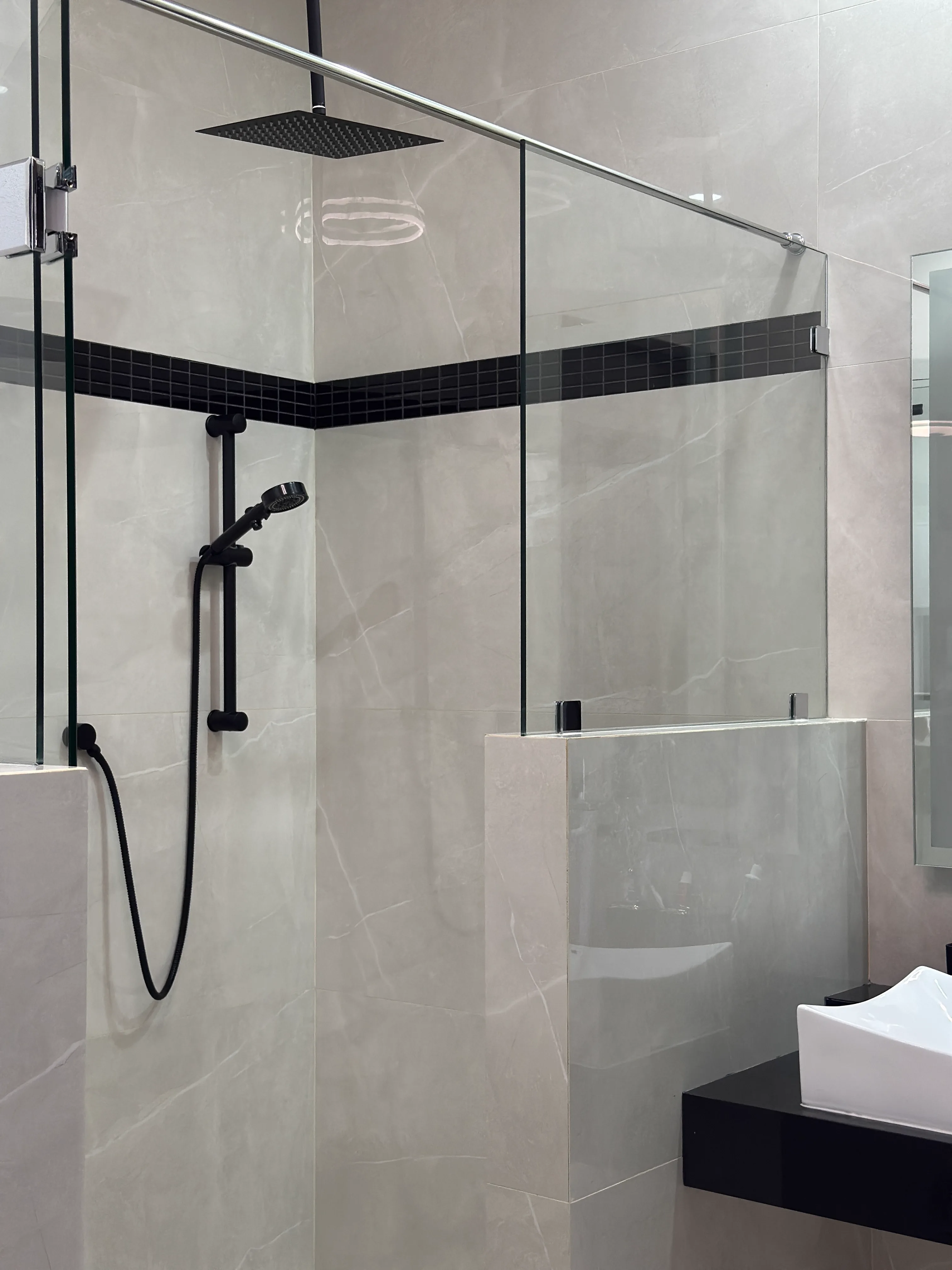 Baño con ducha de lluvia negra, vidrio templado y azulejo mármol — Casa Manglar